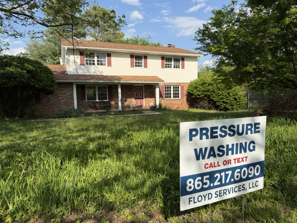 Floyd's Services yard sign in front of freshly pressure washed home