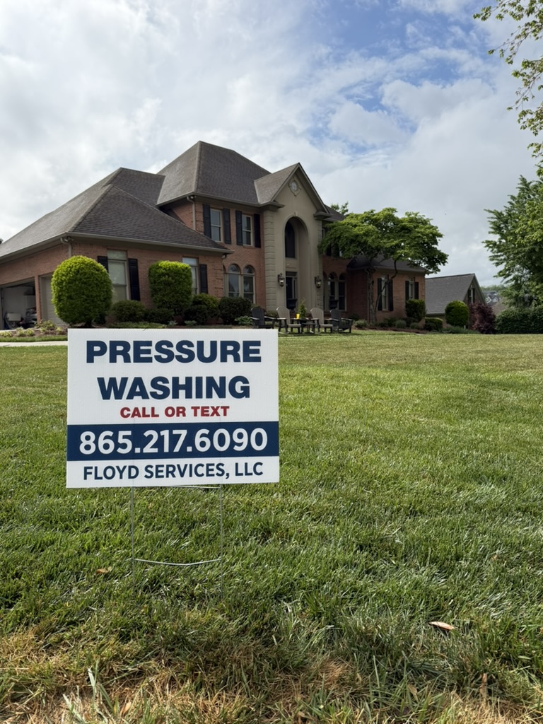 Floyd's Services sign in front of large brick home in Farragut after exterior pressure washing